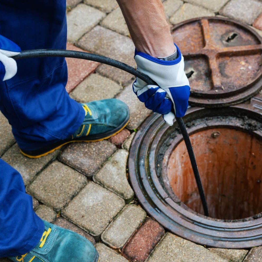 sewer cleaning service – worker clean a clogged drainage with hydro jetting sewer cleaning service - worker clean a clogged drainage with hydro jetting